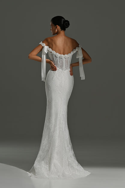 Fitted lace wedding dress with ribbon bows – back view of the lace corset and trailing ribbons