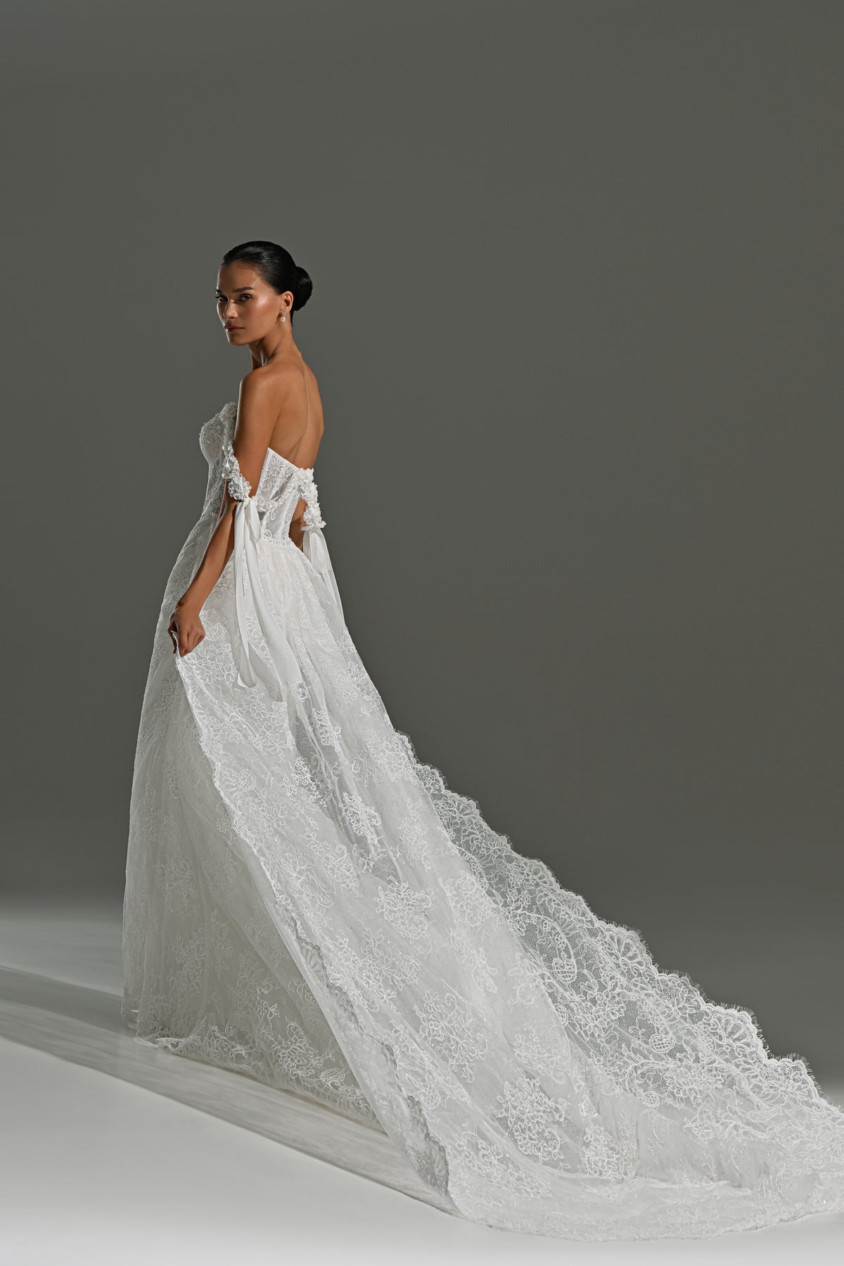 Lace wedding dress with detachable scalloped train – side view showing the lace edge of the train