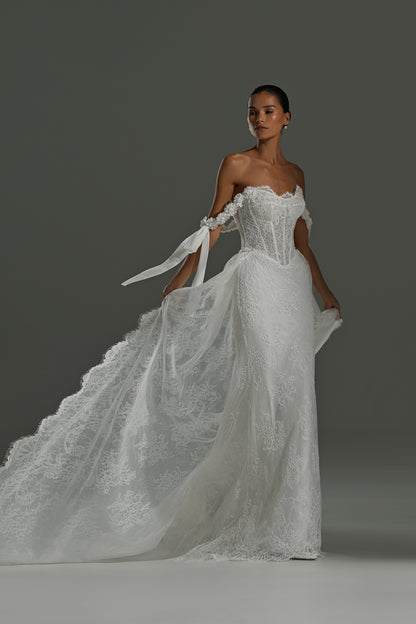 Lace wedding dress with detachable scalloped train – three-quarter view with the train flowing