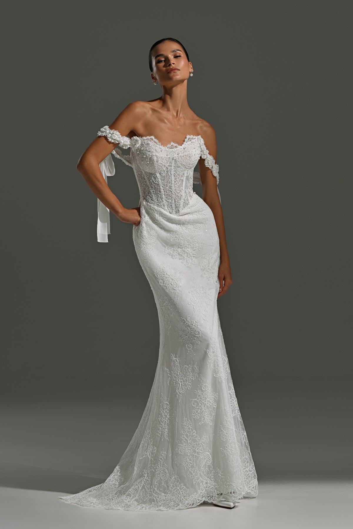 Fitted lace wedding dress with off-shoulder corset and ribbon bows – full-length front view without the overskirt