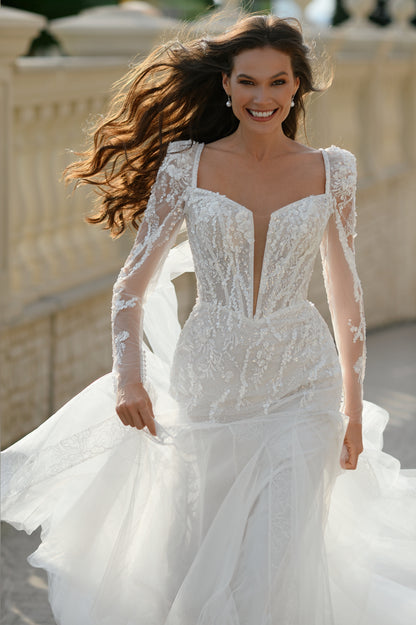 Mermaid wedding dress with long sleeves, bow, and fishtail train