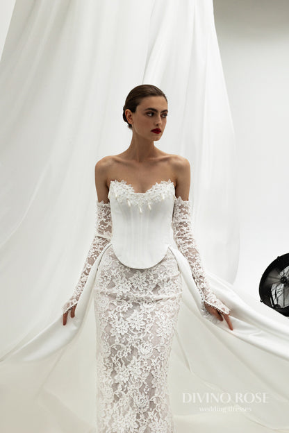 Fitted wedding dress with lace sleeves and corset back.