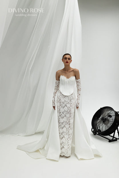 Fitted wedding dress with lace sleeves and corset back.
