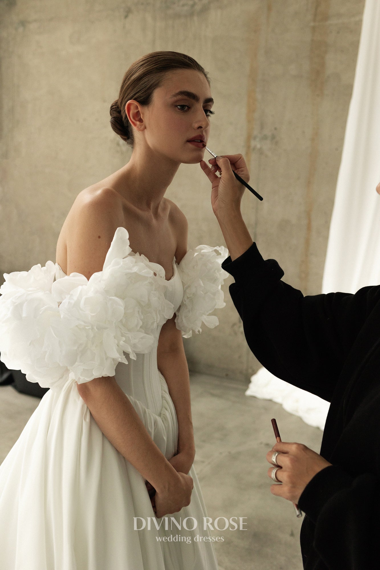 A-line corset wedding dress with boat neckline and sleeves
