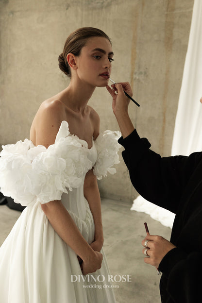 A-line corset wedding dress with boat neckline and sleeves