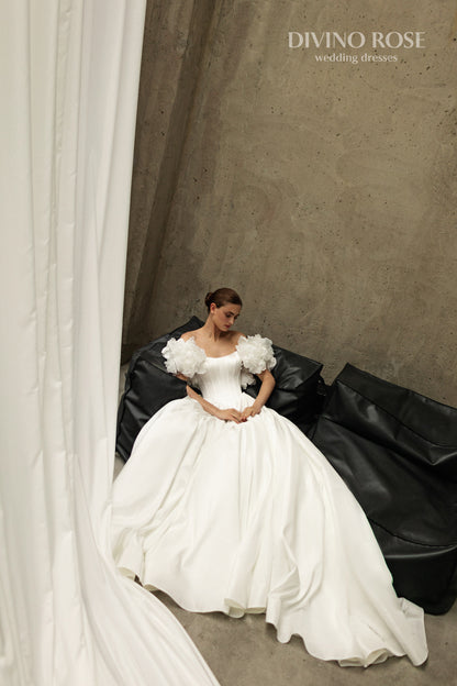 A-line corset wedding dress with boat neckline and sleeves
