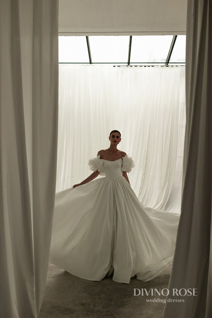 A-line corset wedding dress with boat neckline and sleeves