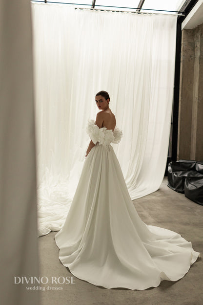 A-line corset wedding dress with boat neckline and sleeves