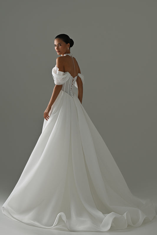 Off-shoulder organza A-line wedding dress with puff sleeves and lace corset – back three-quarter view of the full skirt