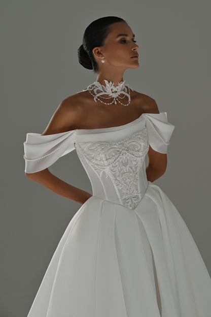 Off-shoulder organza A-line wedding dress – close-up of the puff sleeves and lace corset bodice