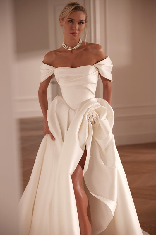 Off-the-shoulder mikado wedding dress with sculpted rose detail and high slit - front view