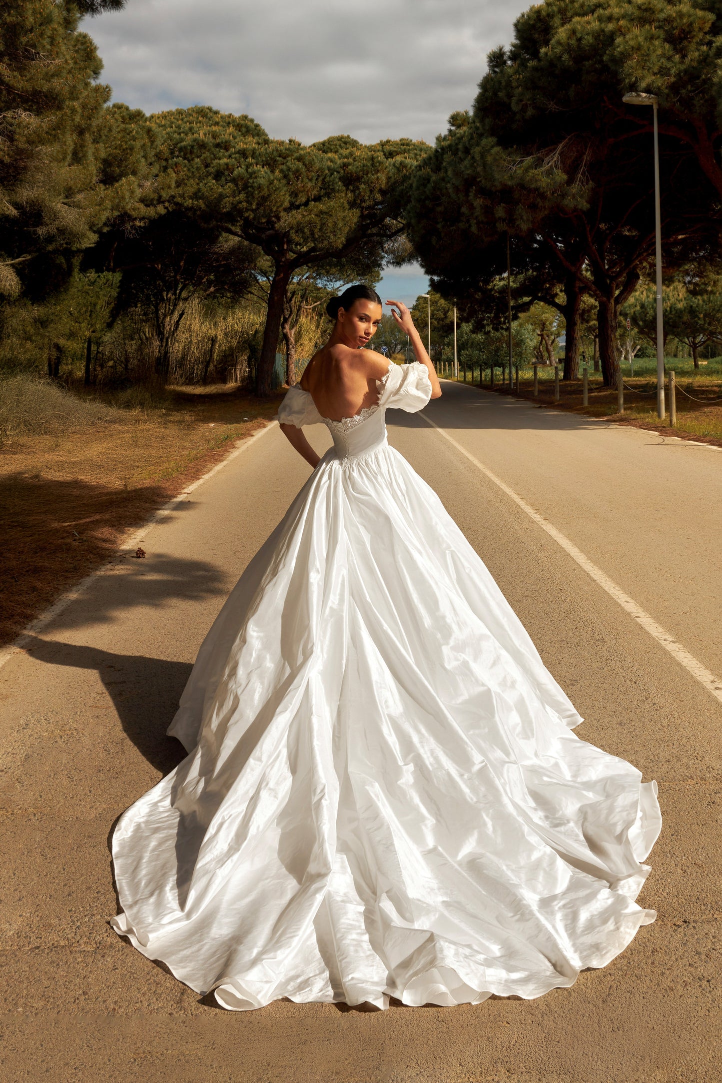 Princess taffeta bridal gown with detachable off-the-shoulder sleeves, draped bodice, straight lace neckline, open back, lace-up closure, and cathedral train.