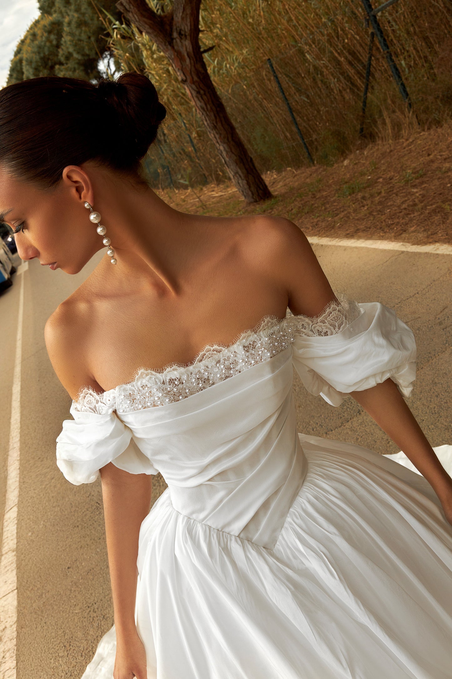Princess taffeta bridal gown with detachable off-the-shoulder sleeves, draped bodice, straight lace neckline, open back, lace-up closure, and cathedral train.