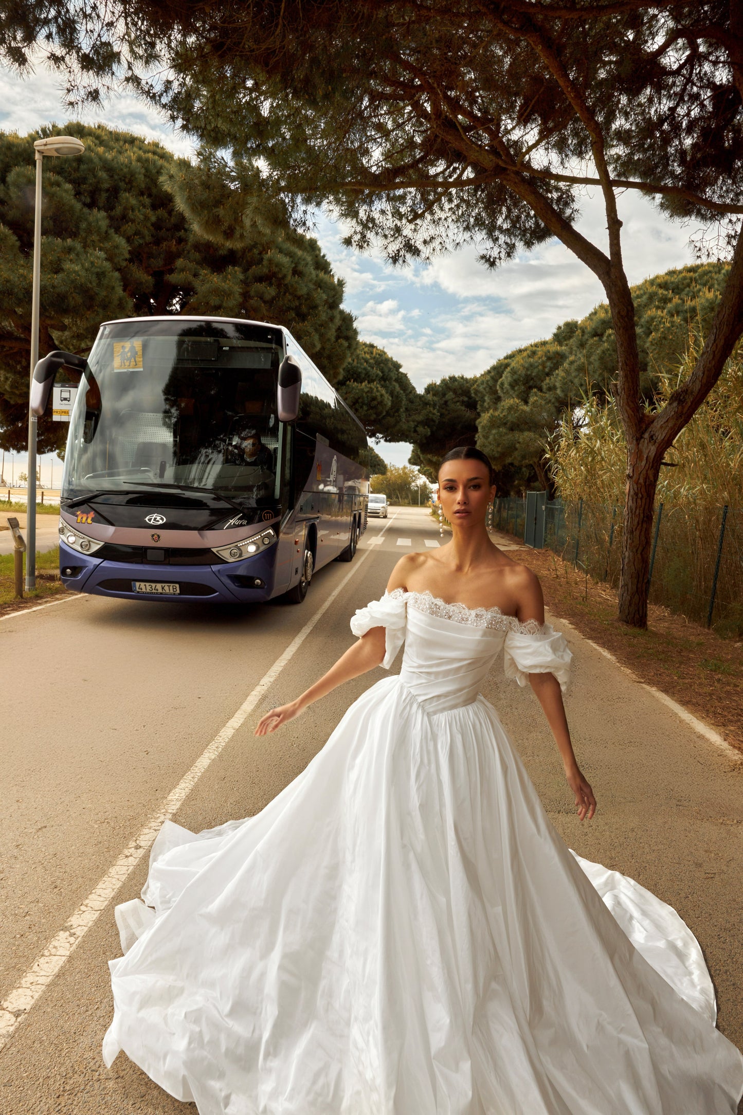 Princess taffeta bridal gown with detachable off-the-shoulder sleeves, draped bodice, straight lace neckline, open back, lace-up closure, and cathedral train.