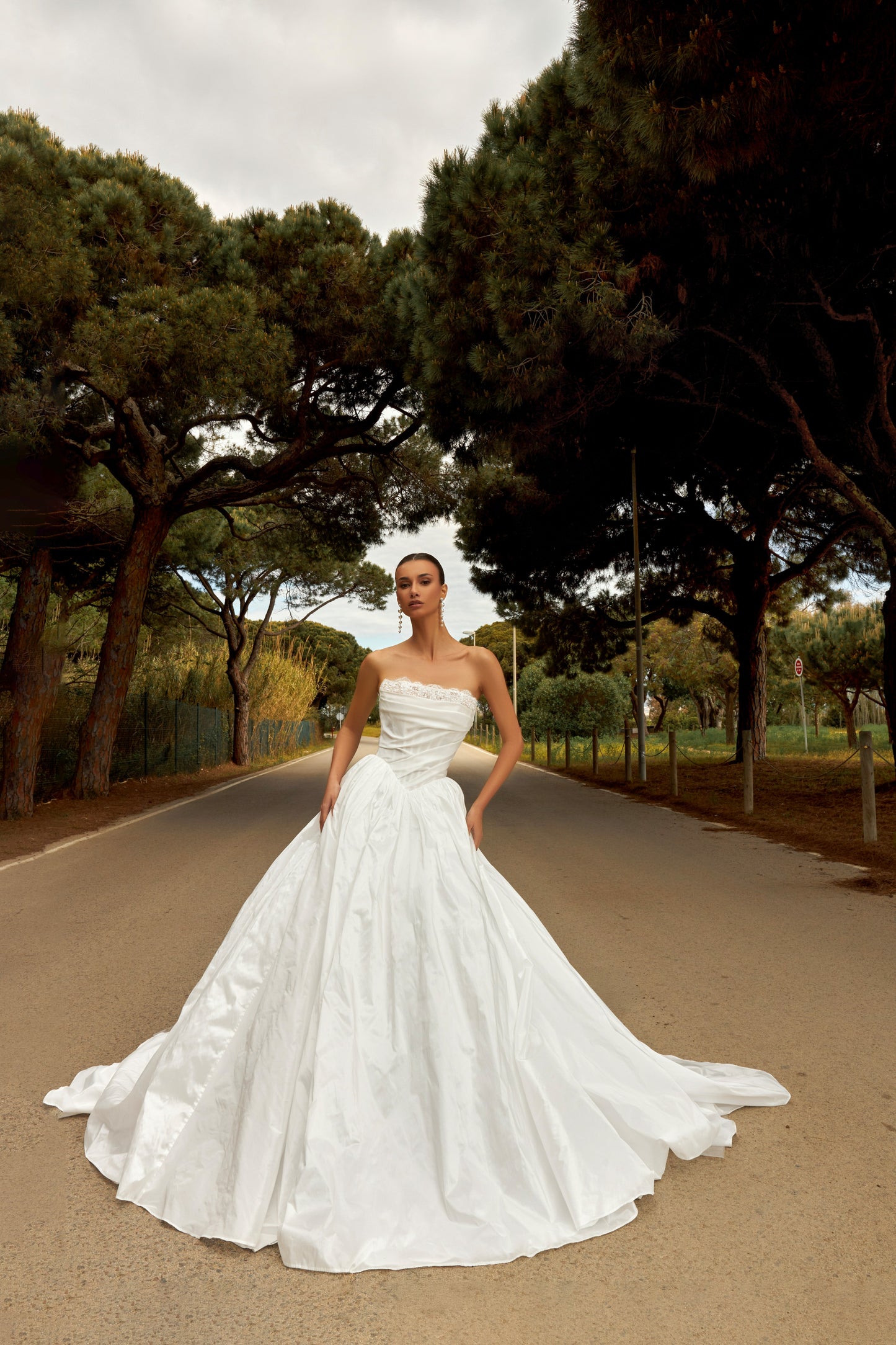 Princess taffeta bridal gown with detachable off-the-shoulder sleeves, draped bodice, straight lace neckline, open back, lace-up closure, and cathedral train.