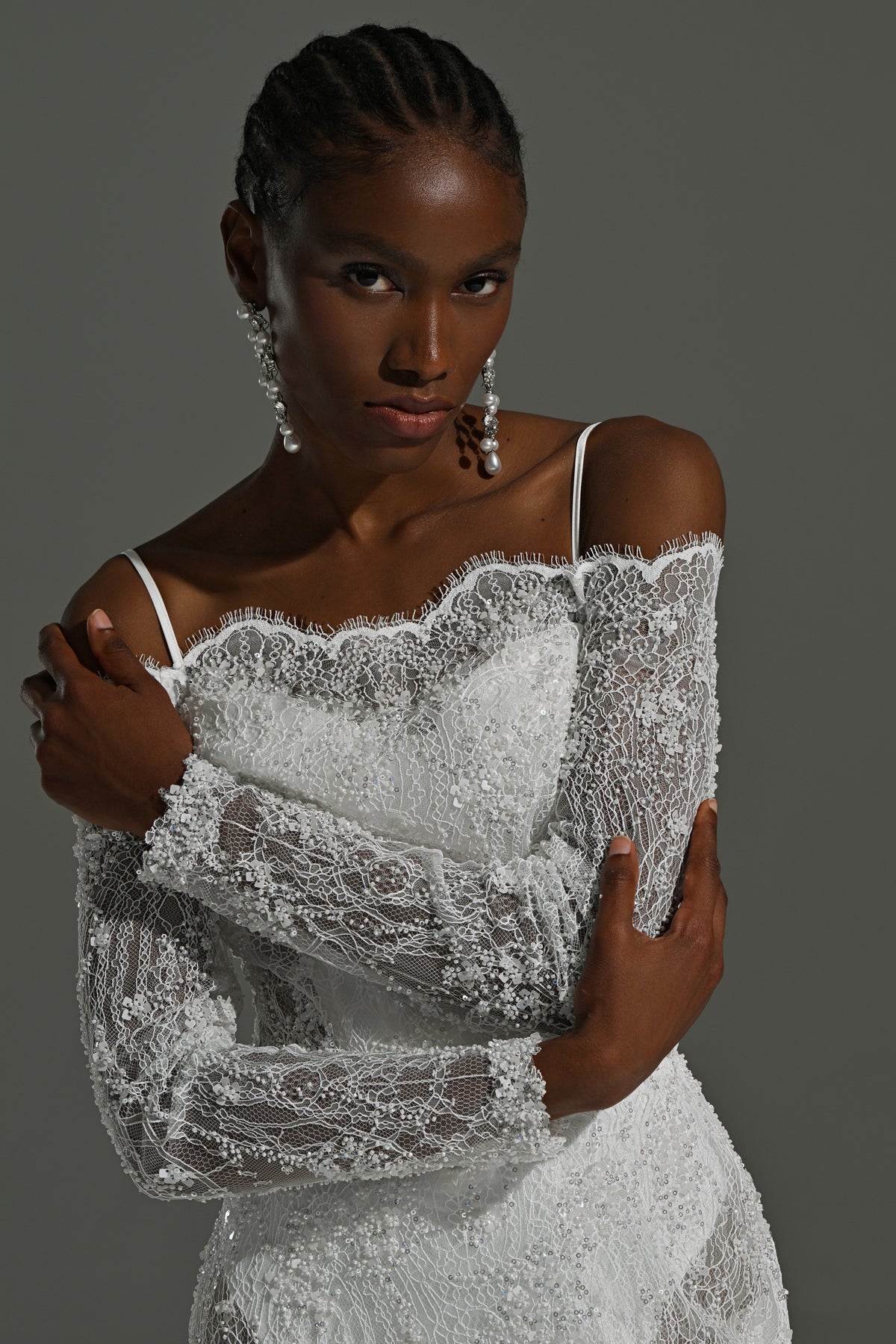 Off-shoulder lace mermaid wedding dress – close-up of the lace neckline, spaghetti strap and long lace sleeve