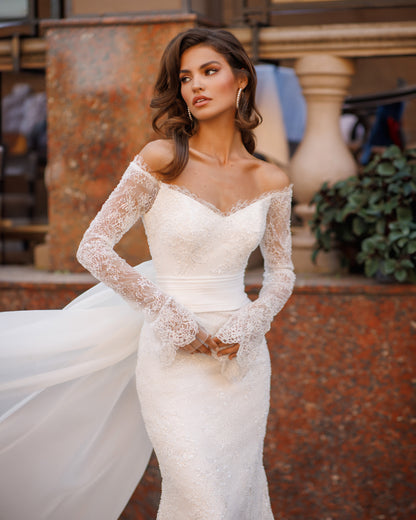 Mermaid lace wedding dress with long sleeves and V-neckline.