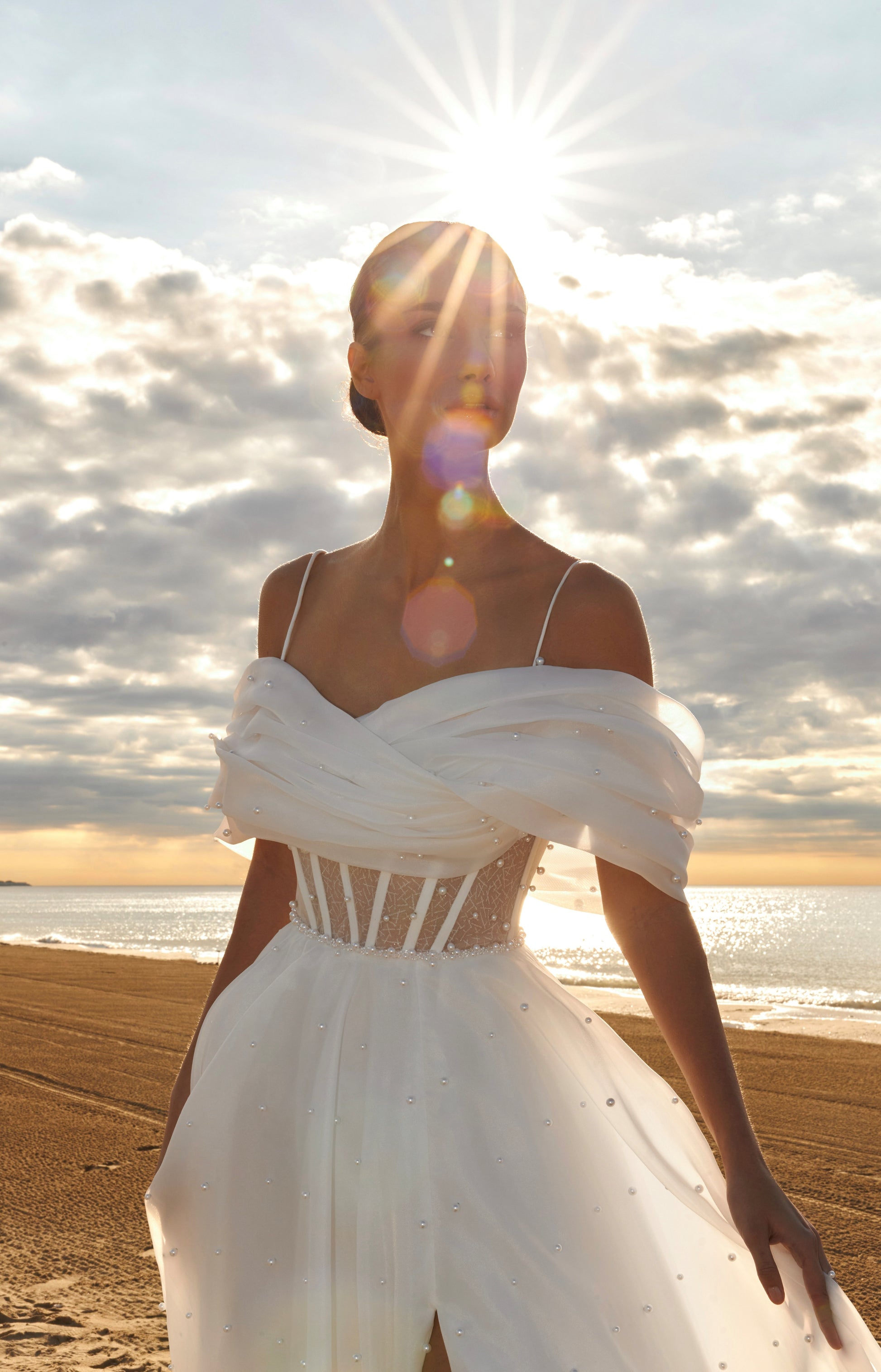 Organza A-line bridal gown with off-shoulder crossed draped neckline, spaghetti straps, pearl details, slit skirt, open back lace-up closure, and court train.