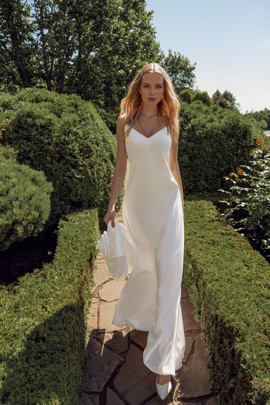 Minimalist sleeveless wedding dress with 3D floral jacket.