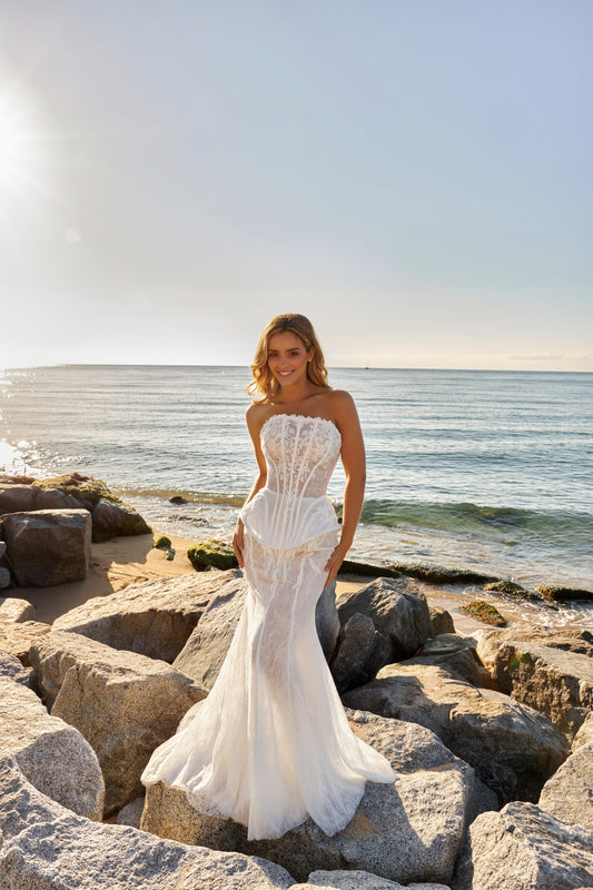 Bride in strapless lace corset wedding dress with tulle A-line slit skirt and optional fishtail train overlay.