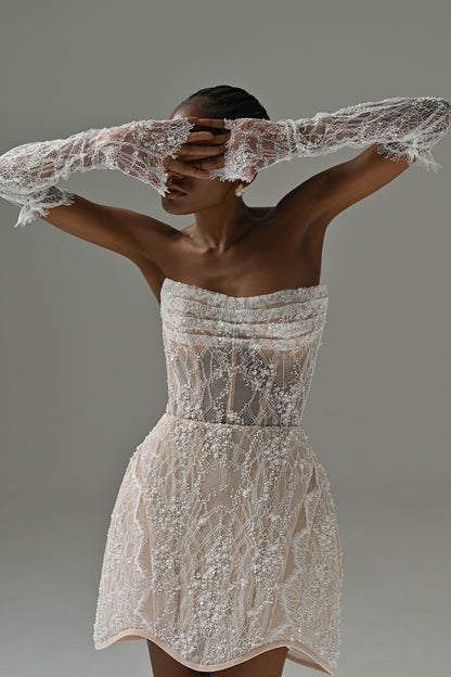 Strapless lace mini wedding dress – bodice and skirt detail with lace sleeves raised over the face