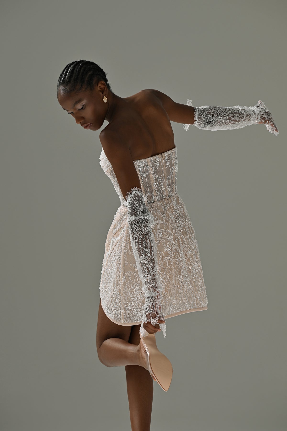 Strapless lace mini wedding dress – side view showing the open back and lace sleeves