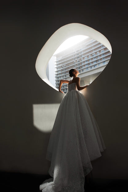 Bride wearing Celeste lace and tulle ball gown with pearl corset and chapel train.