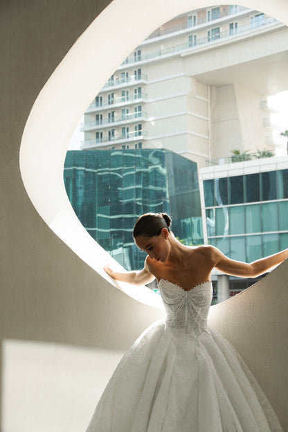Bride wearing Celeste lace and tulle ball gown with pearl corset and chapel train.