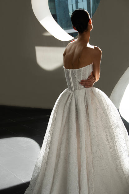 Bride wearing Celeste lace and tulle ball gown with pearl corset and chapel train.