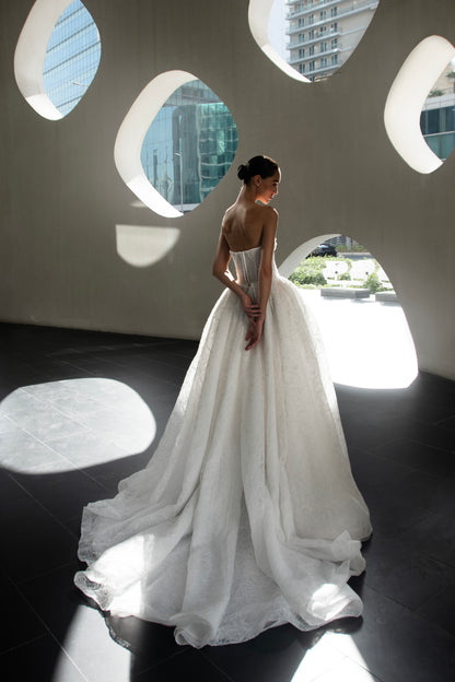 Bride wearing Celeste lace and tulle ball gown with pearl corset and chapel train.