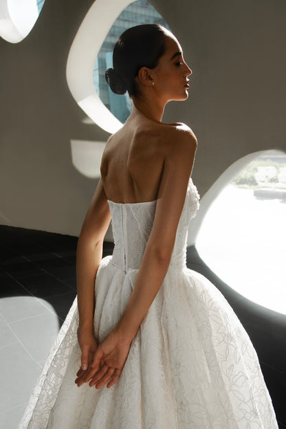 Bride wearing Celeste lace and tulle ball gown with pearl corset and chapel train.