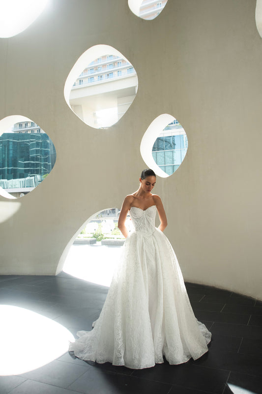 Bride wearing Celeste lace and tulle ball gown with pearl corset and chapel train.