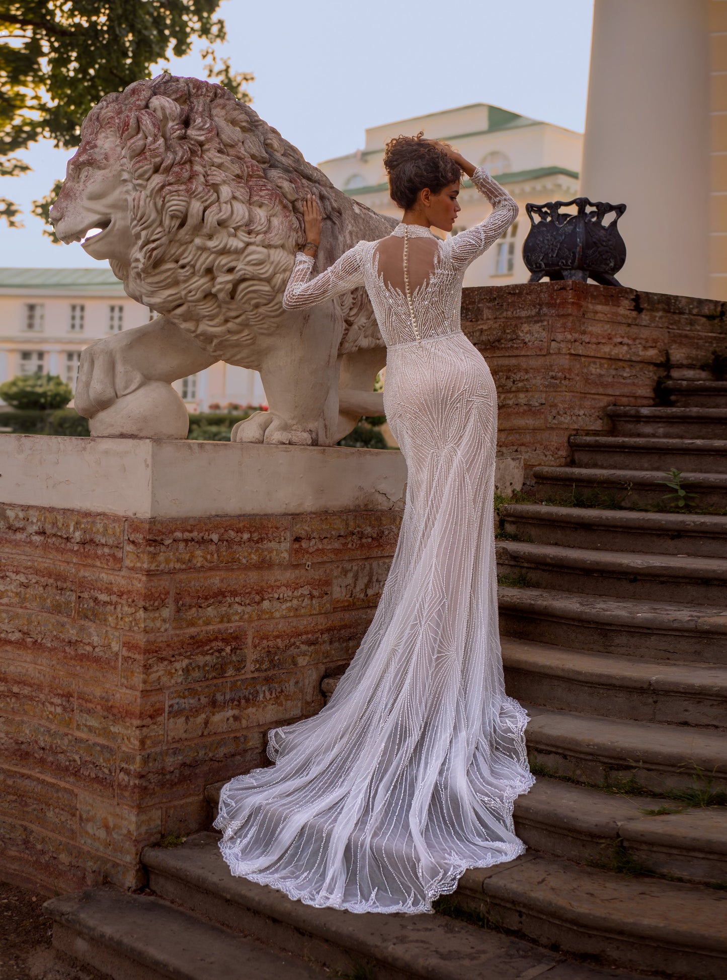 Beaded lace mermaid wedding gown with long sleeves and illusion neckline
