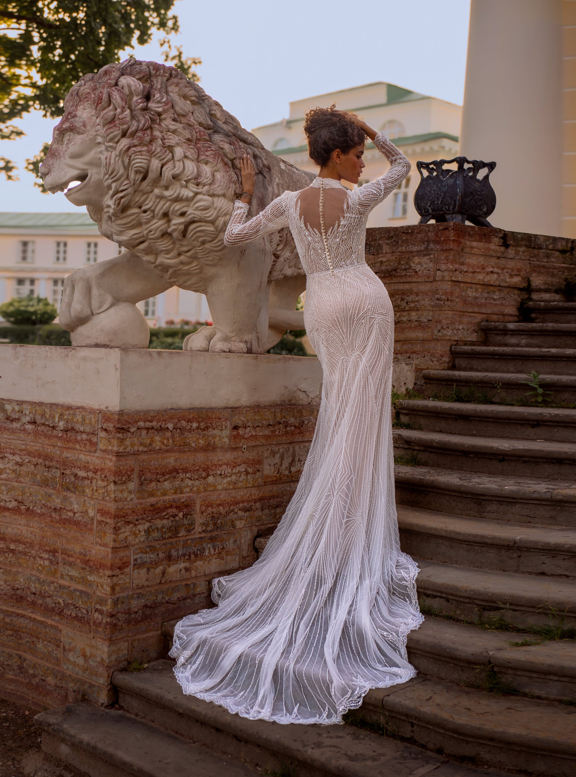 Beaded lace mermaid wedding gown with long sleeves and illusion neckline