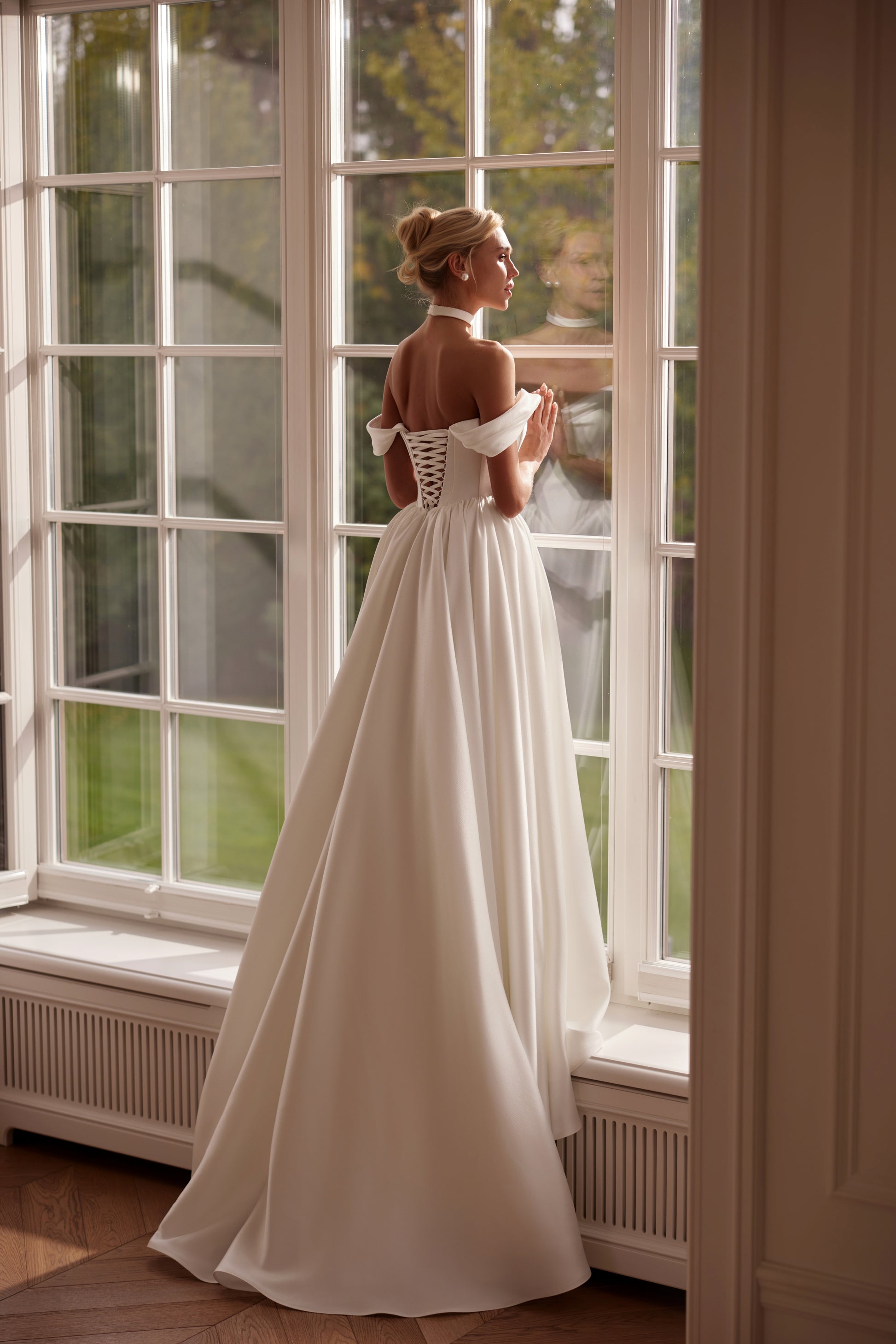 Luxury off-shoulder mikado A-line wedding dress with folded neckline, structured bodice, and corset back — modern elegant bridal gown.