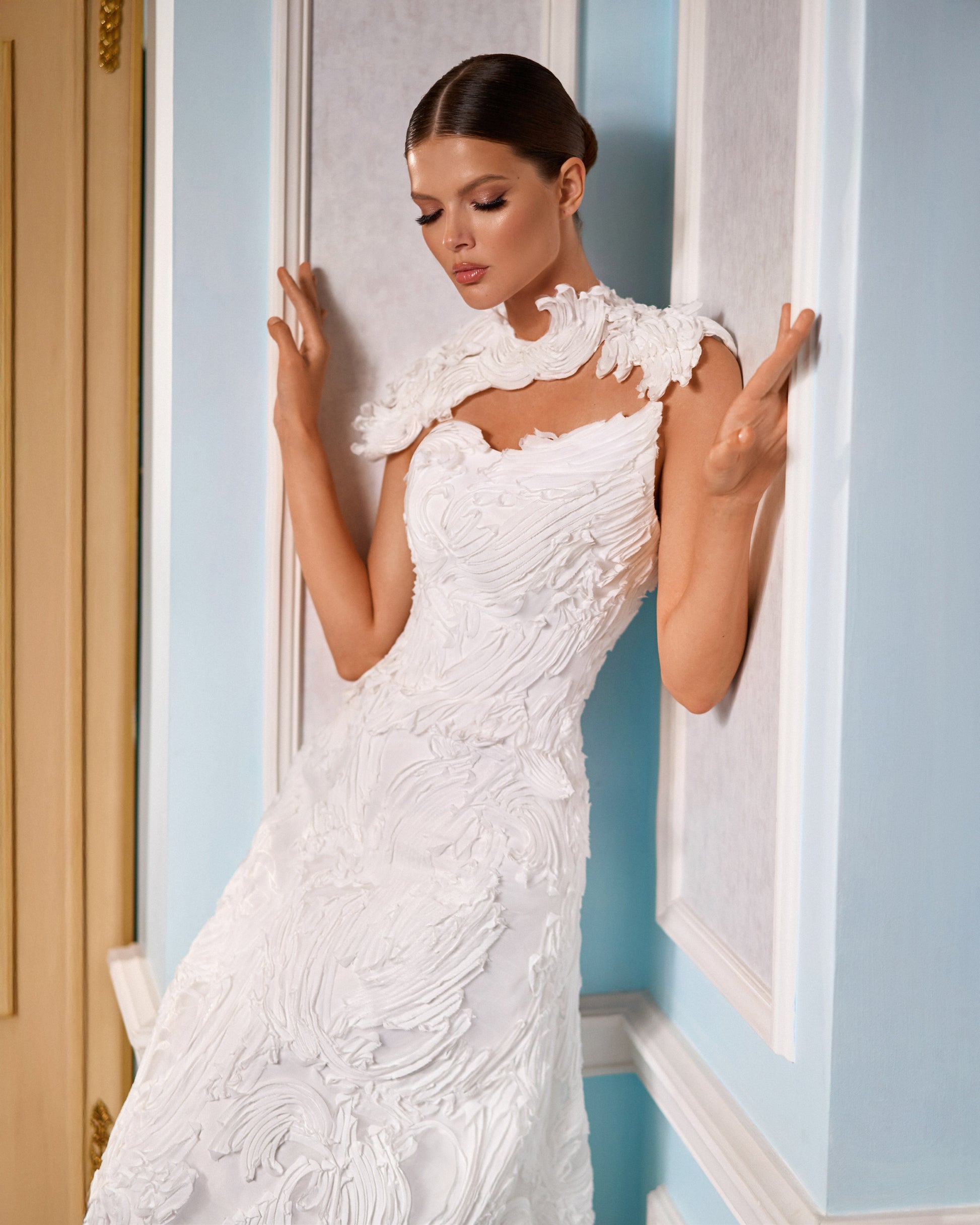 Explore this sculpted lace A-line wedding dress with removable bolero, strapless bodice option, and chapel train. A couture bridal gown offering elegance and versatility.