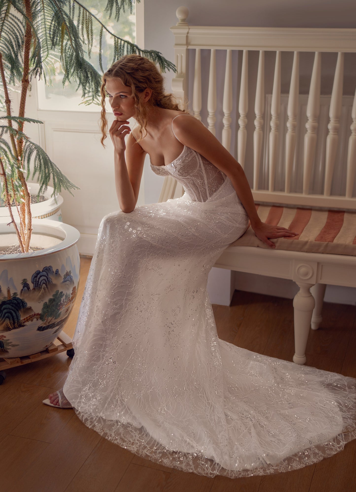 Bride wearing sculpted lace mermaid wedding gown with corset and optional bolero.