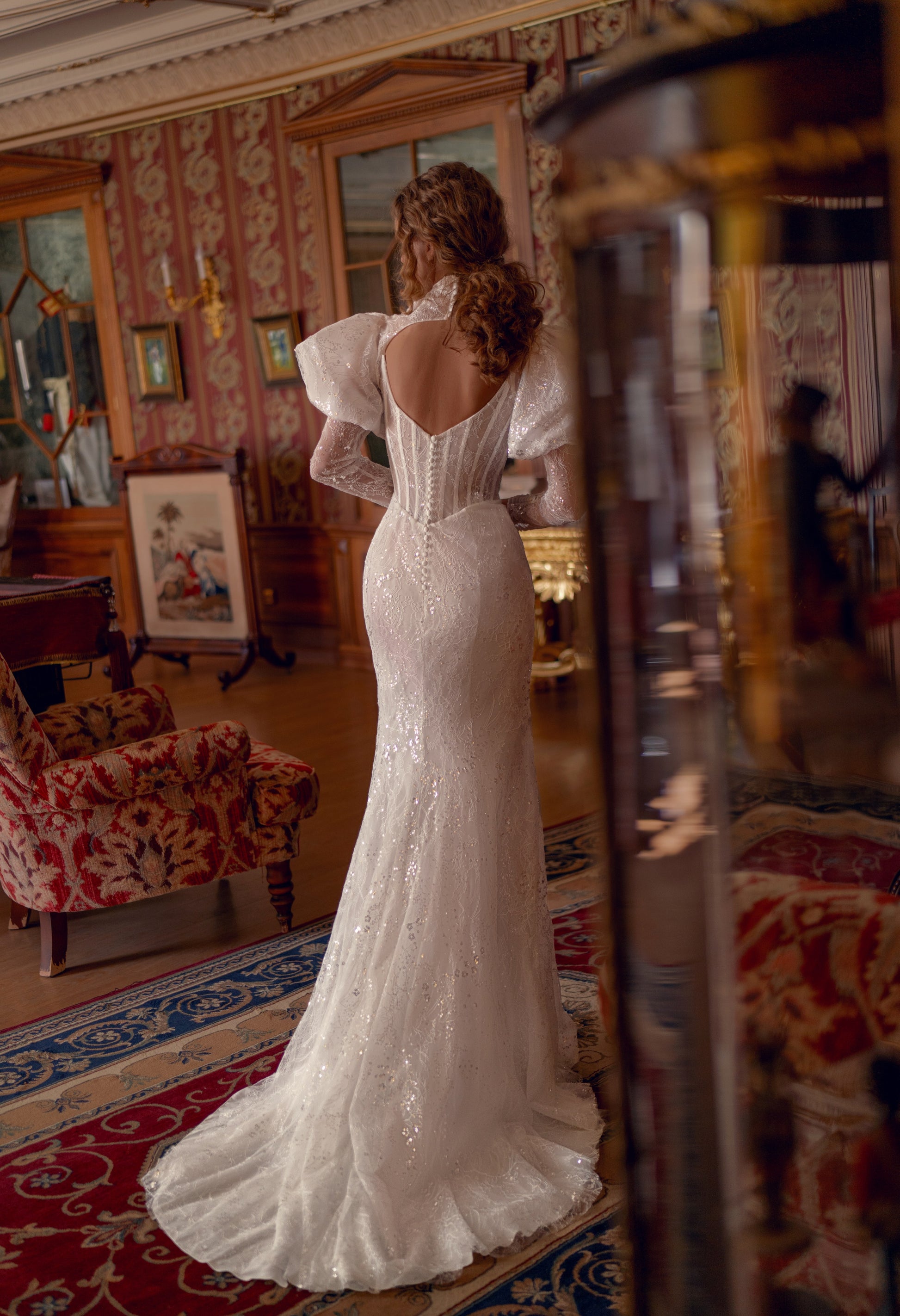 Bride wearing sculpted lace mermaid wedding gown with corset and optional bolero.