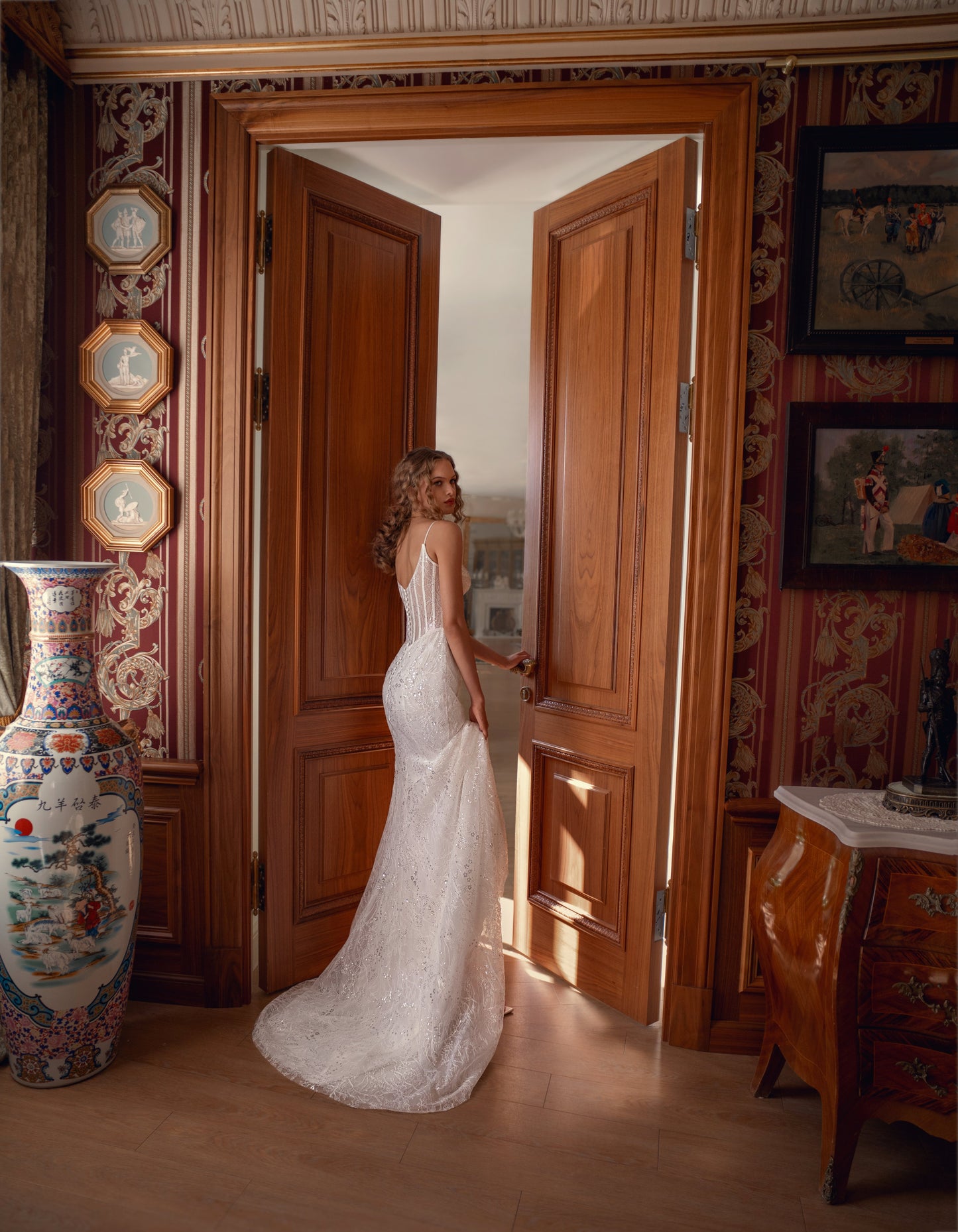 Bride wearing sculpted lace mermaid wedding gown with corset and optional bolero.
