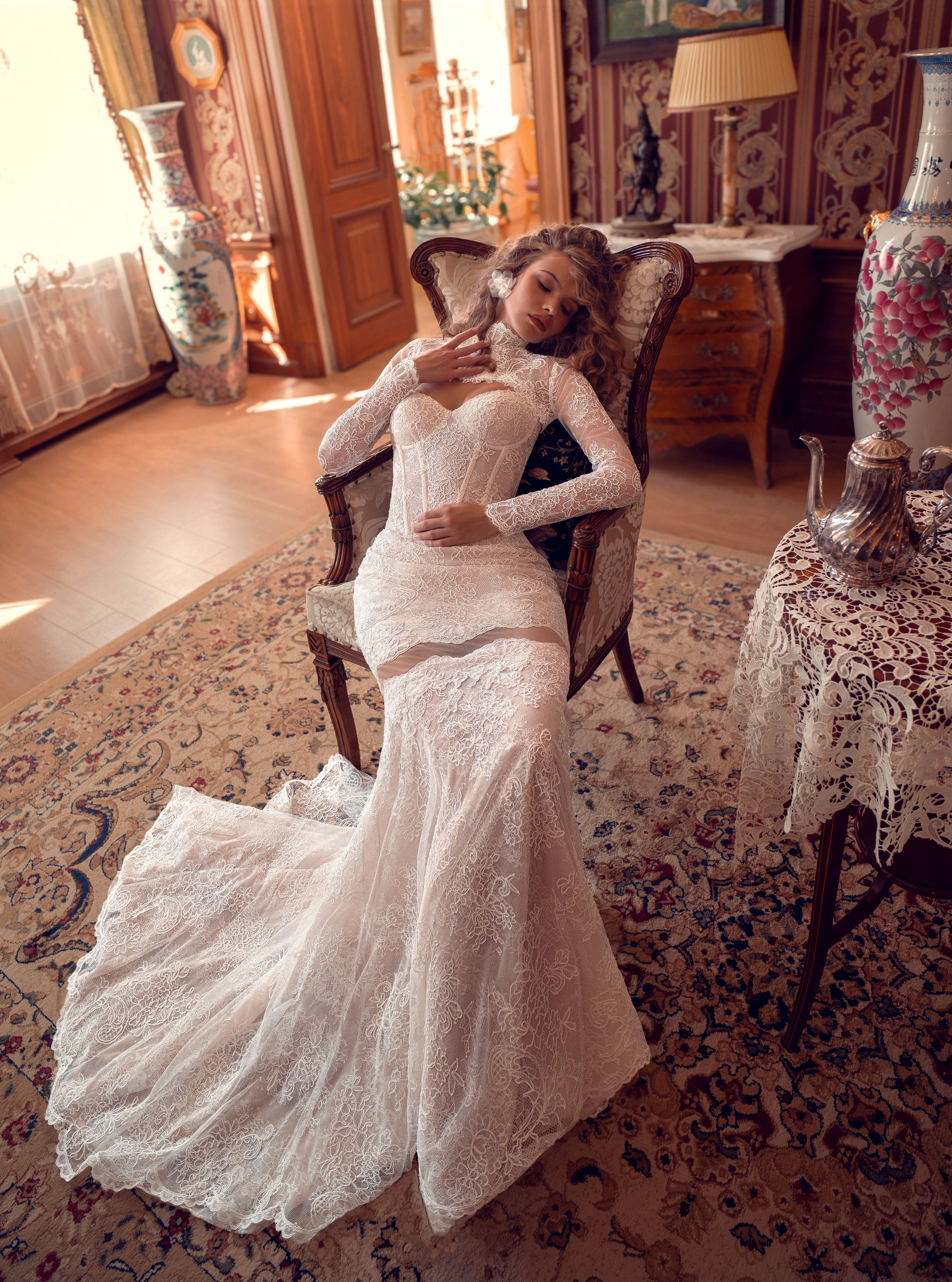 Bride wearing lace mermaid wedding gown with removable long-sleeve bolero