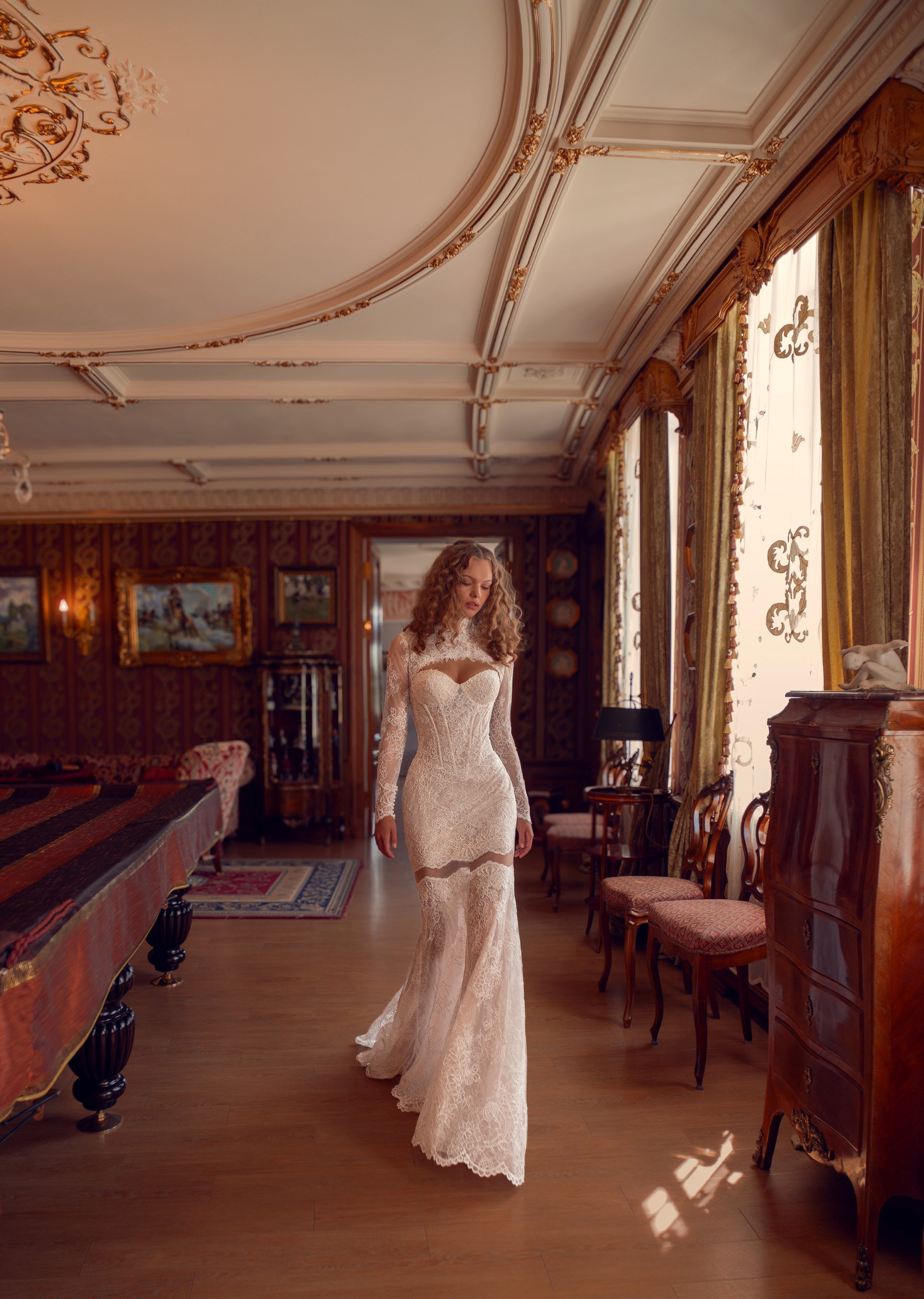 Bride wearing lace mermaid wedding gown with removable long-sleeve bolero