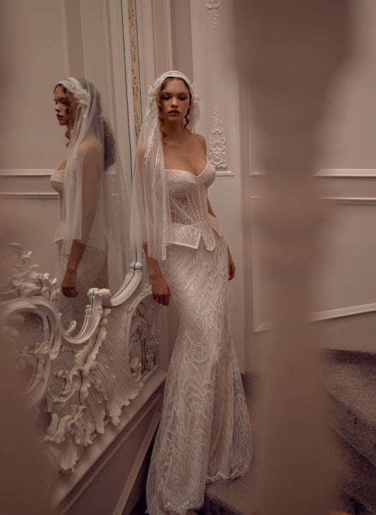 Lace strapless corset wedding gown with basque waist and mermaid-inspired silhouette