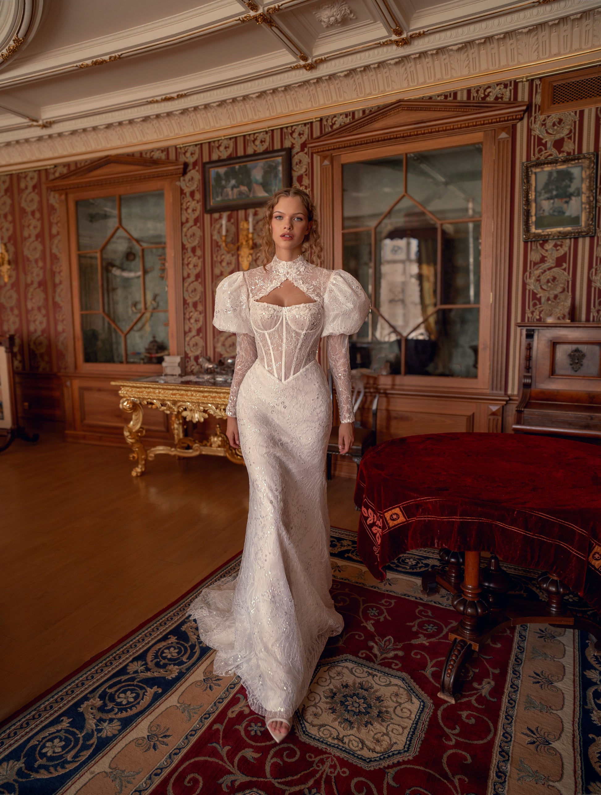 Bride wearing sculpted lace mermaid wedding gown with corset and optional bolero.