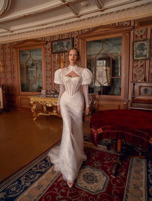 Bride wearing sculpted lace mermaid wedding gown with corset and optional bolero.