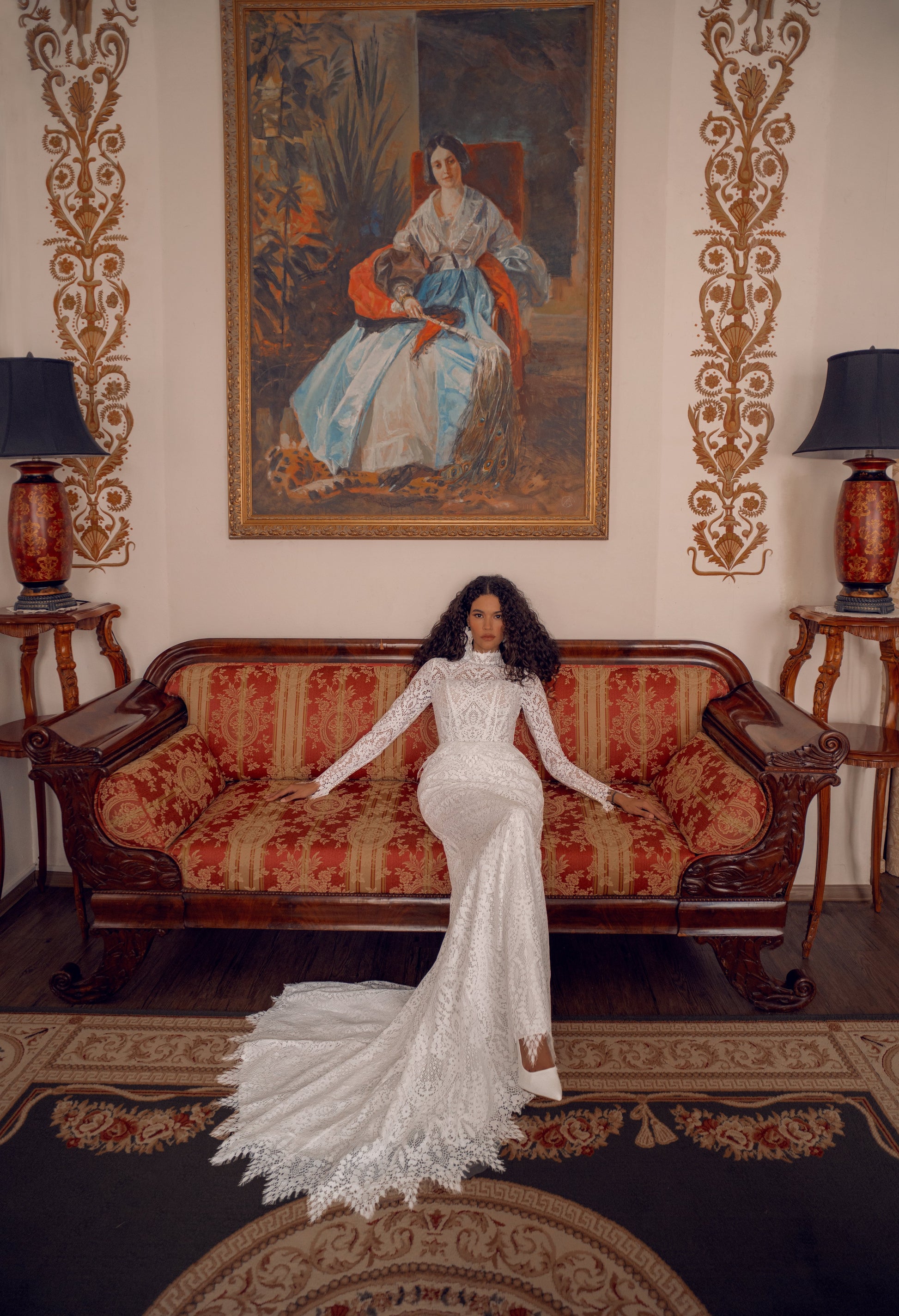 Long-sleeve high-neck lace mermaid wedding gown with open back and scalloped train.