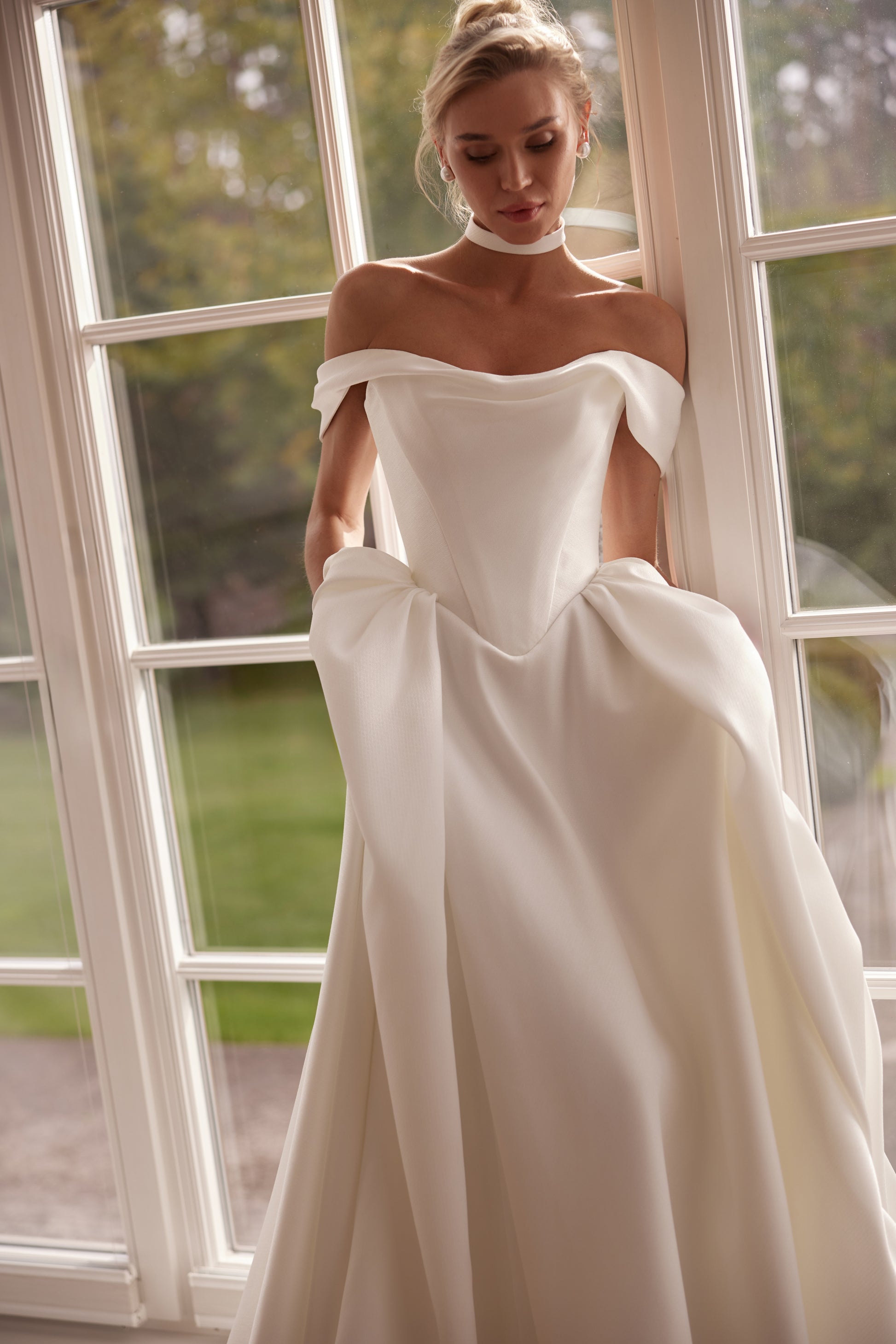 Luxury off-shoulder mikado A-line wedding dress with folded neckline, structured bodice, and corset back — modern elegant bridal gown.