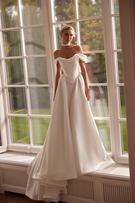 Luxury off-shoulder mikado A-line wedding dress with folded neckline, structured bodice, and corset back — modern elegant bridal gown.