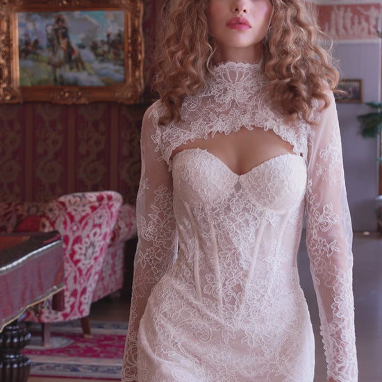 Bride wearing lace mermaid wedding gown with removable long-sleeve bolero