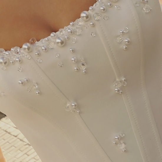 Sleeveless A-line Mikado bridal gown with wide straps, drop-down waist, zip closure, and chapel train. Classic wedding dress in timeless modern style.