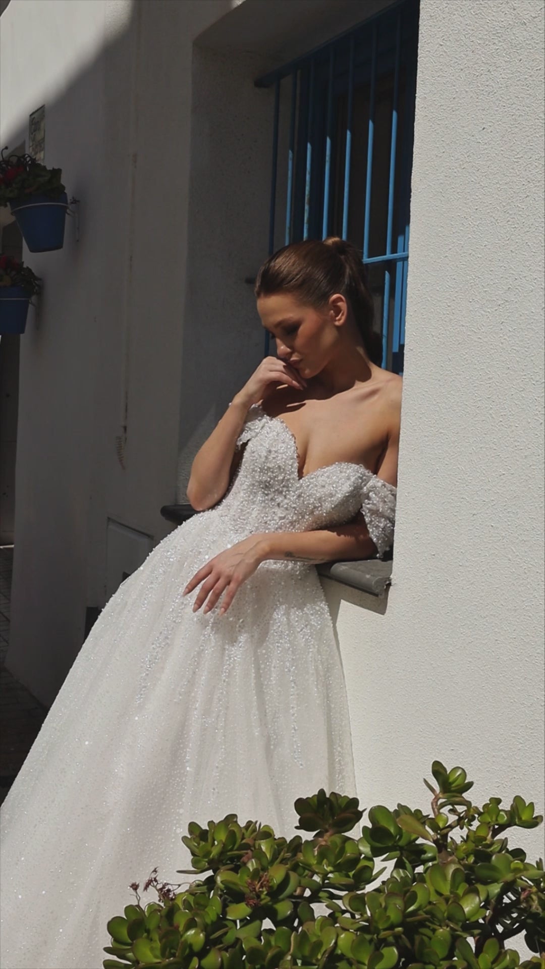 Sleeveless A-line lace bridal gown with sweetheart neckline, pearl straps, pearl and sequin embroidery, and glittering tulle skirt.